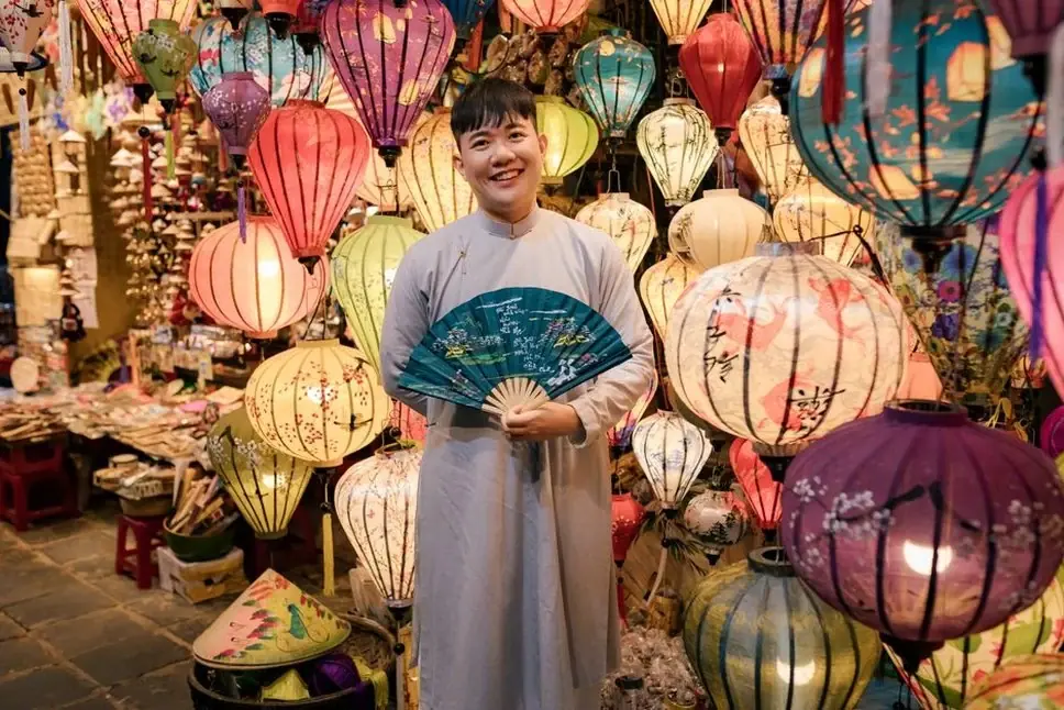 Smiling lantern vendor in Hoi An ancient town Vietnam