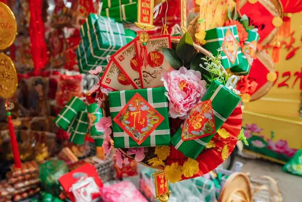 Colorful Tet festival decorations with gift boxes and flowers in Vietnam