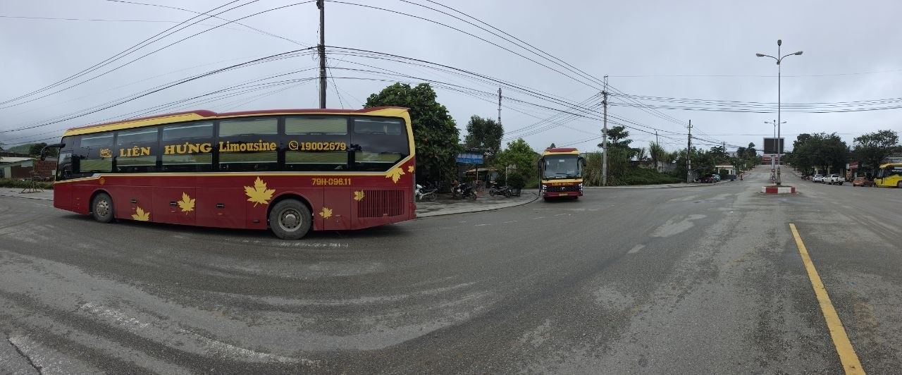 A land border checkpoint crossing point with buses waiting to cross between Vietnam and Laos