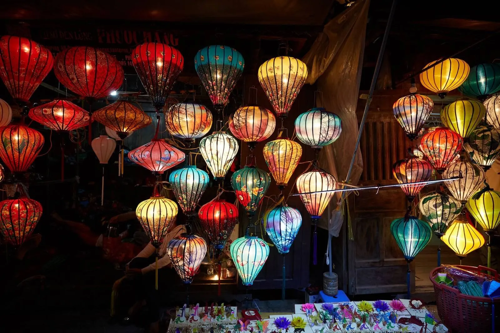 Rows of colorful silk lanterns for sale at a lantern shop in Hoi An