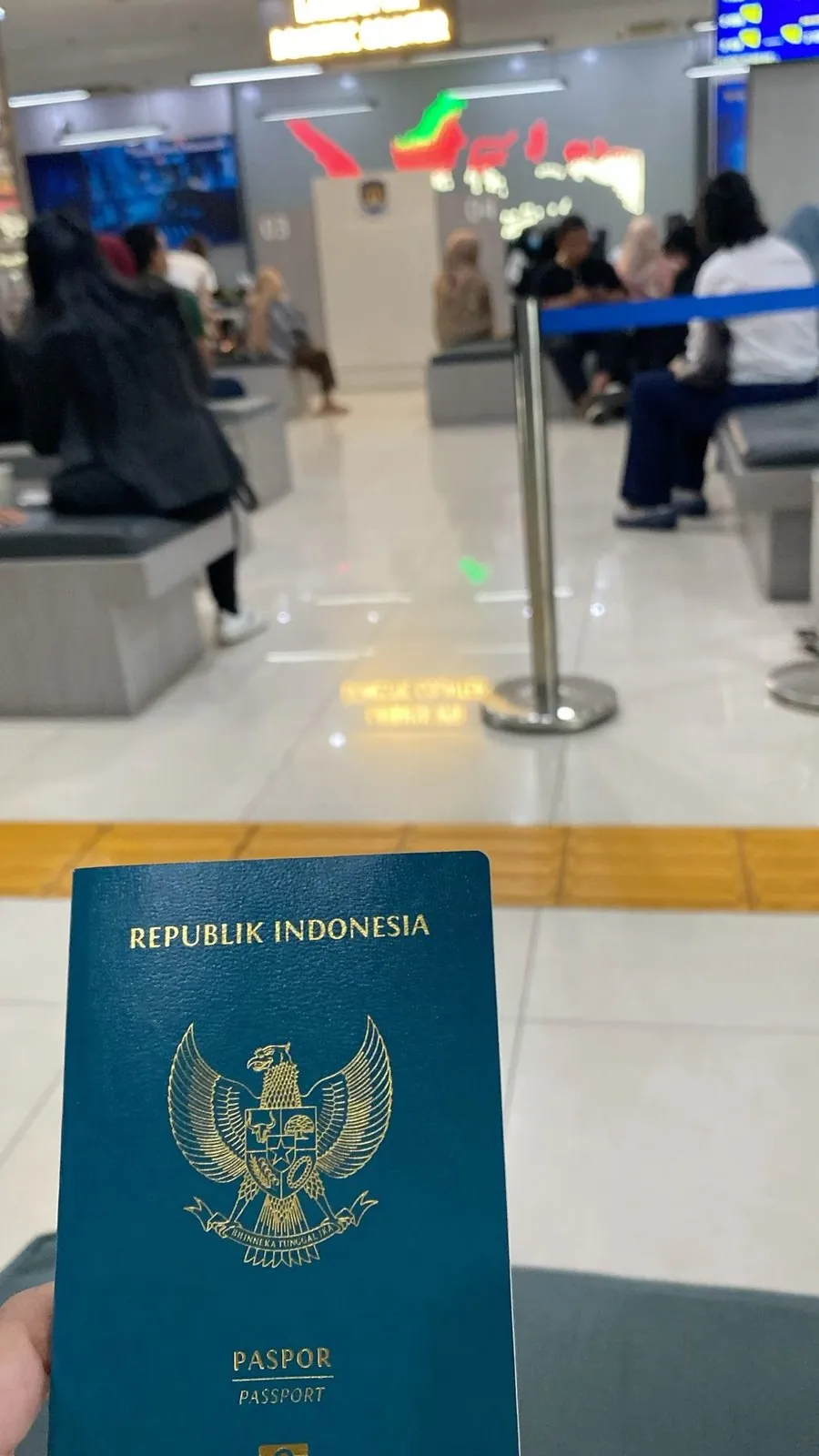 Traveler holding an open passport while going through immigration paperwork