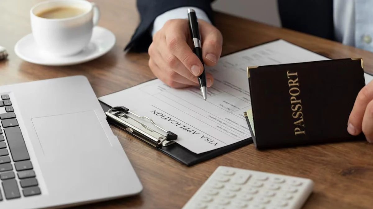 applying for Vietnam e-visa — person with passport and pen next to laptop