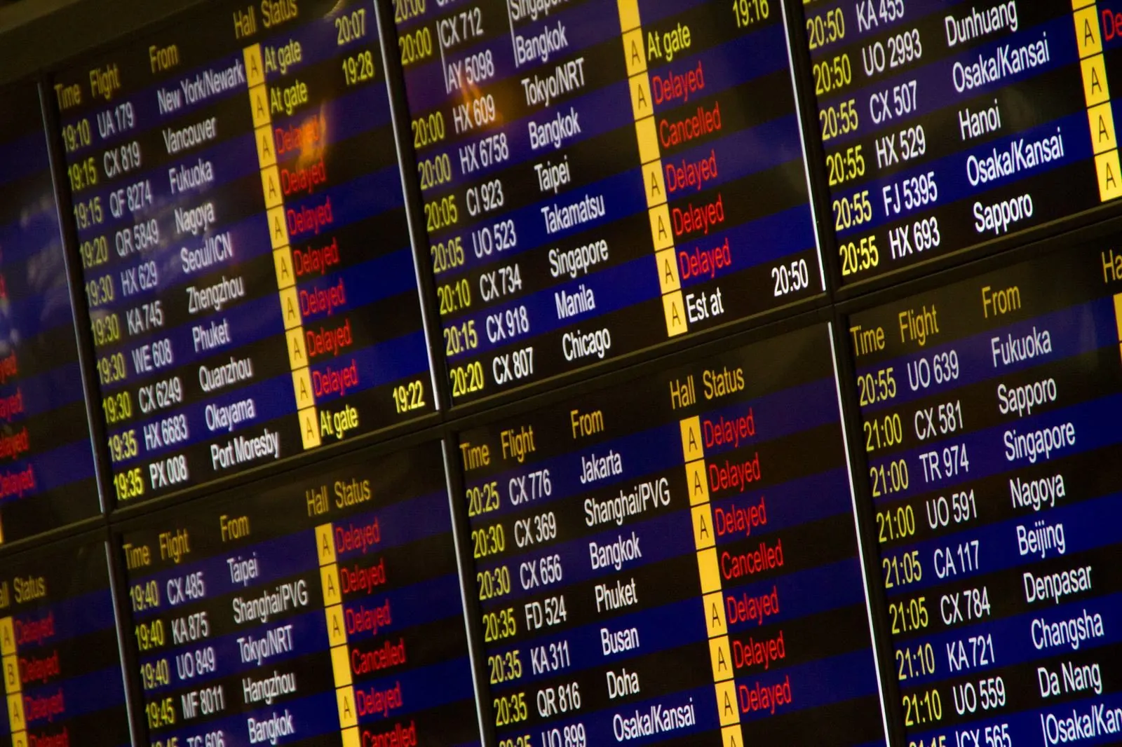 Digital departure board listing international flights and destinations