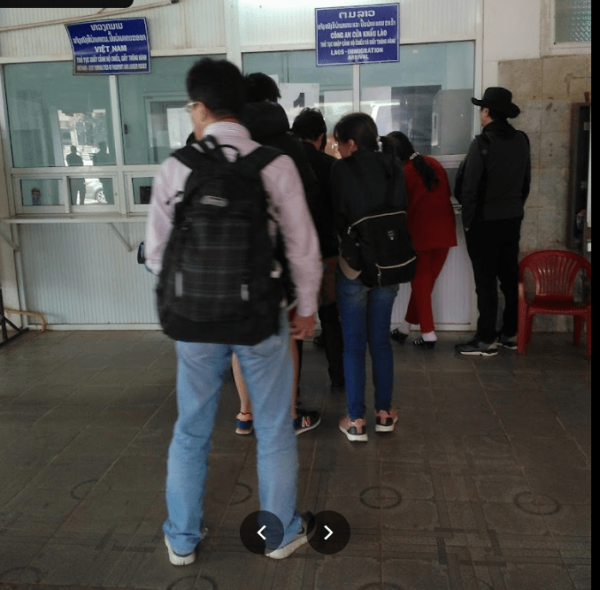 Travelers waiting in queue at the Lao Bao immigration window — the actual scene at the Vietnam-side counter