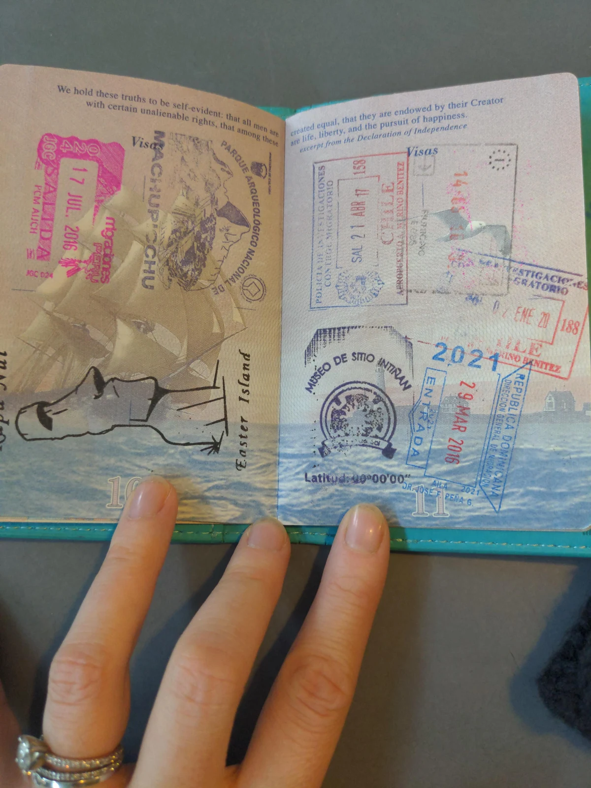 Passport with Vietnam entry stamp and digital arrival card QR code on a phone screen