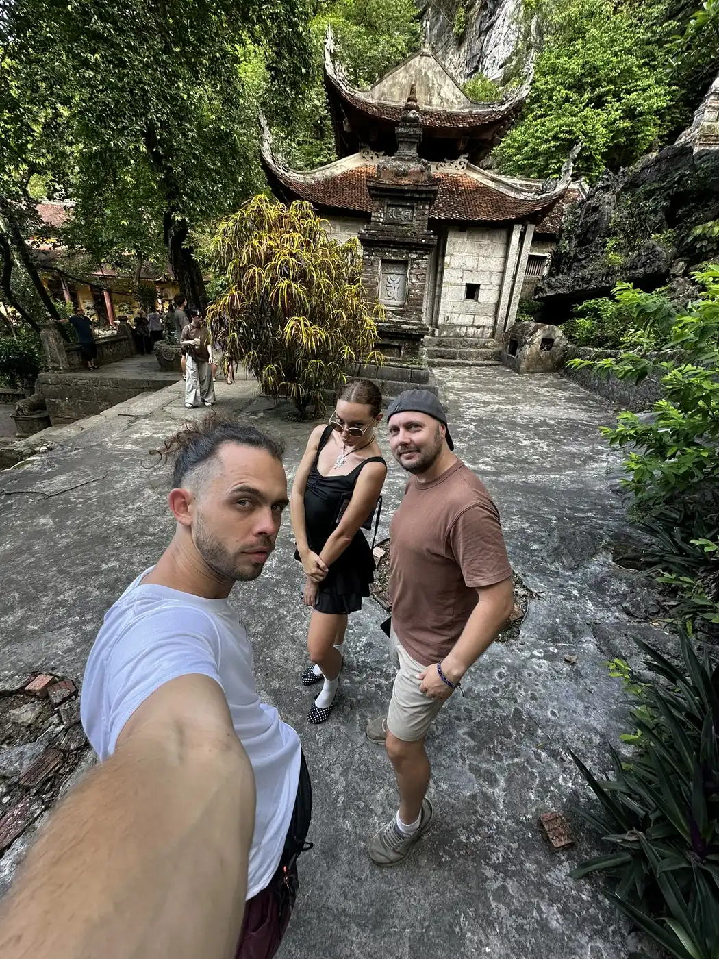 Three travelers in front of an ancient pagoda in Ninh Binh