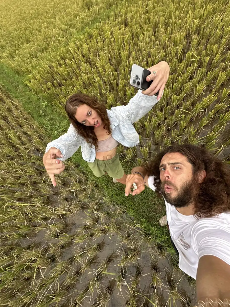 Travelers taking a selfie in a rice paddy in northern Vietnam