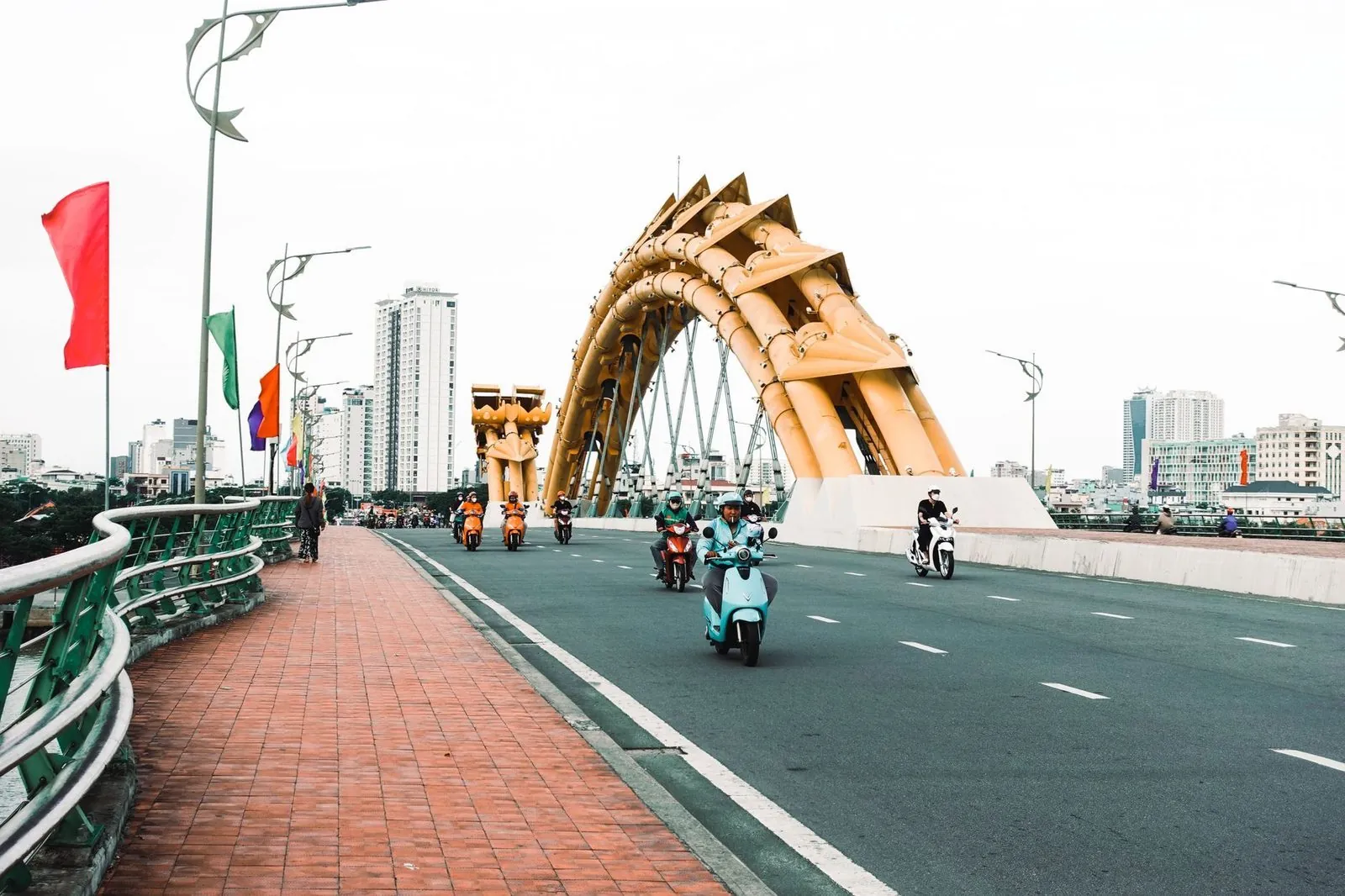 Motorbikes crossing the Dragon Bridge in Da Nang on a clear day