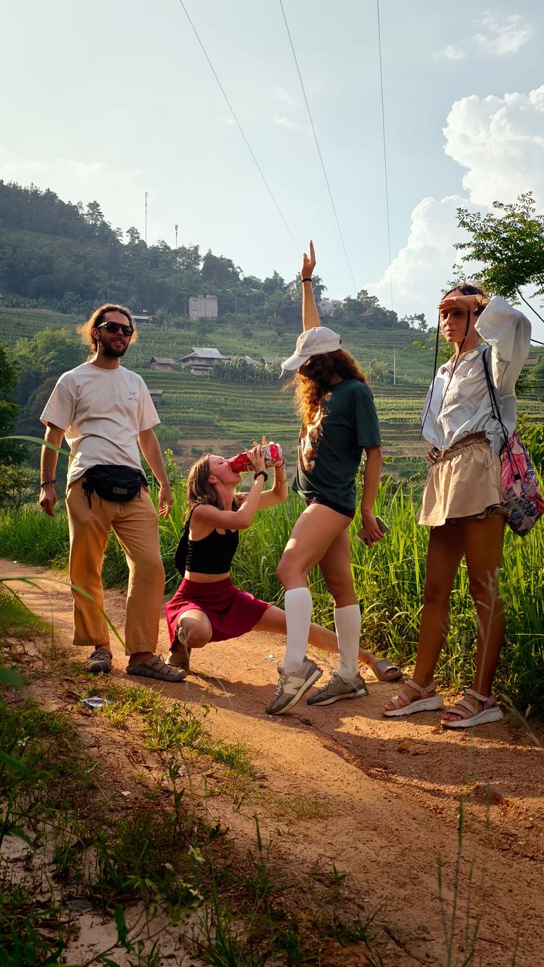 Group walking a dirt trail through rice terraces in northern Vietnam