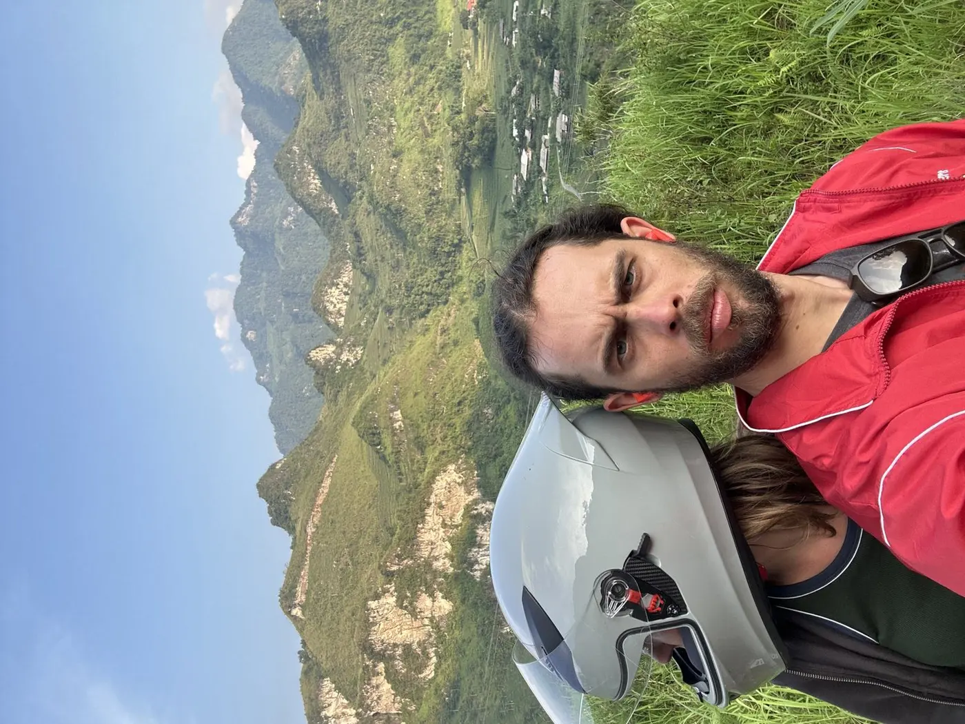 Rider with a motorbike helmet overlooking a mountain valley in Vietnam