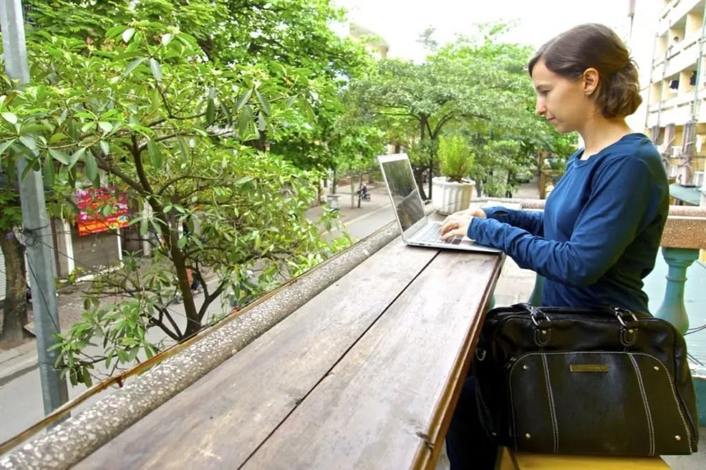 Expat working on a laptop in Hanoi — the kind of long-stay traveler who eventually hits a visa deadline