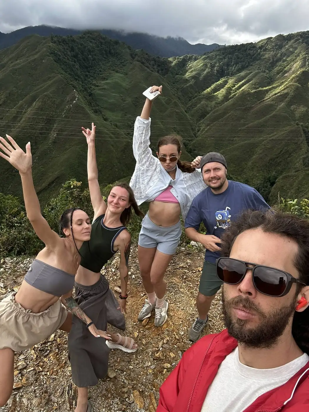 Group of travelers at a mountain viewpoint in Moc Chau, Vietnam