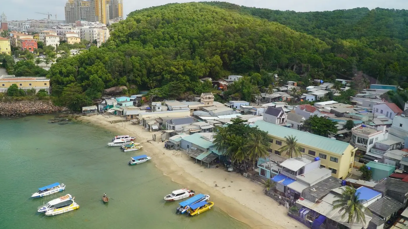 Fishing village with boats and tall buildings behind