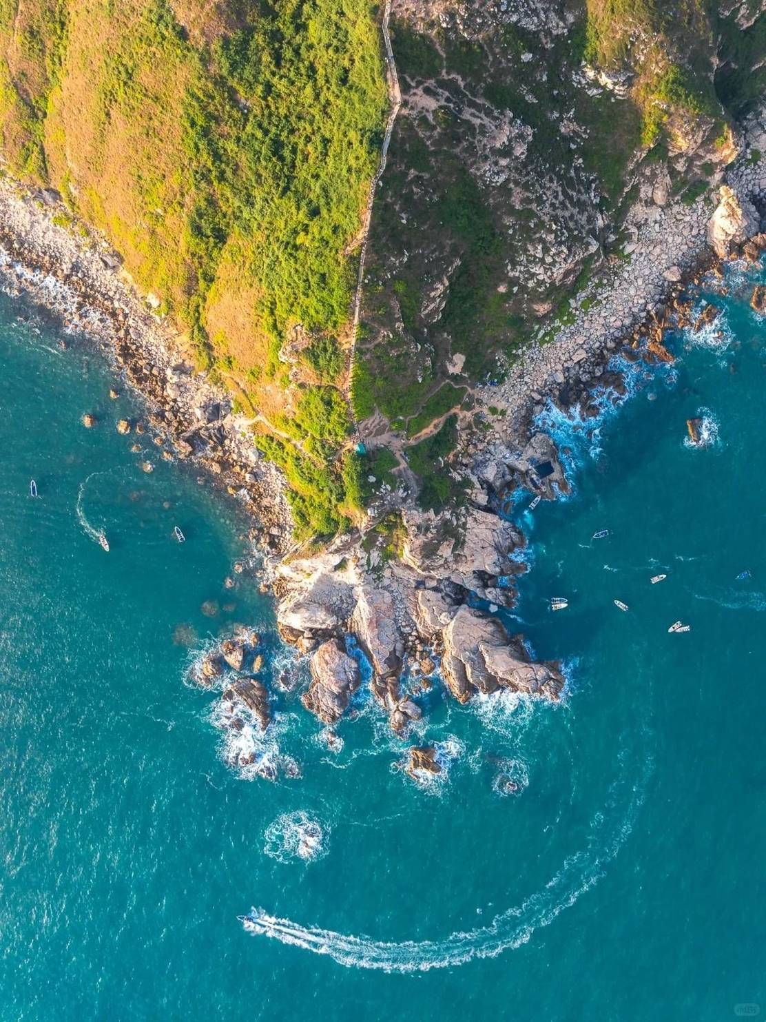 Aerial view of a rocky Vietnamese headland meeting turquoise water