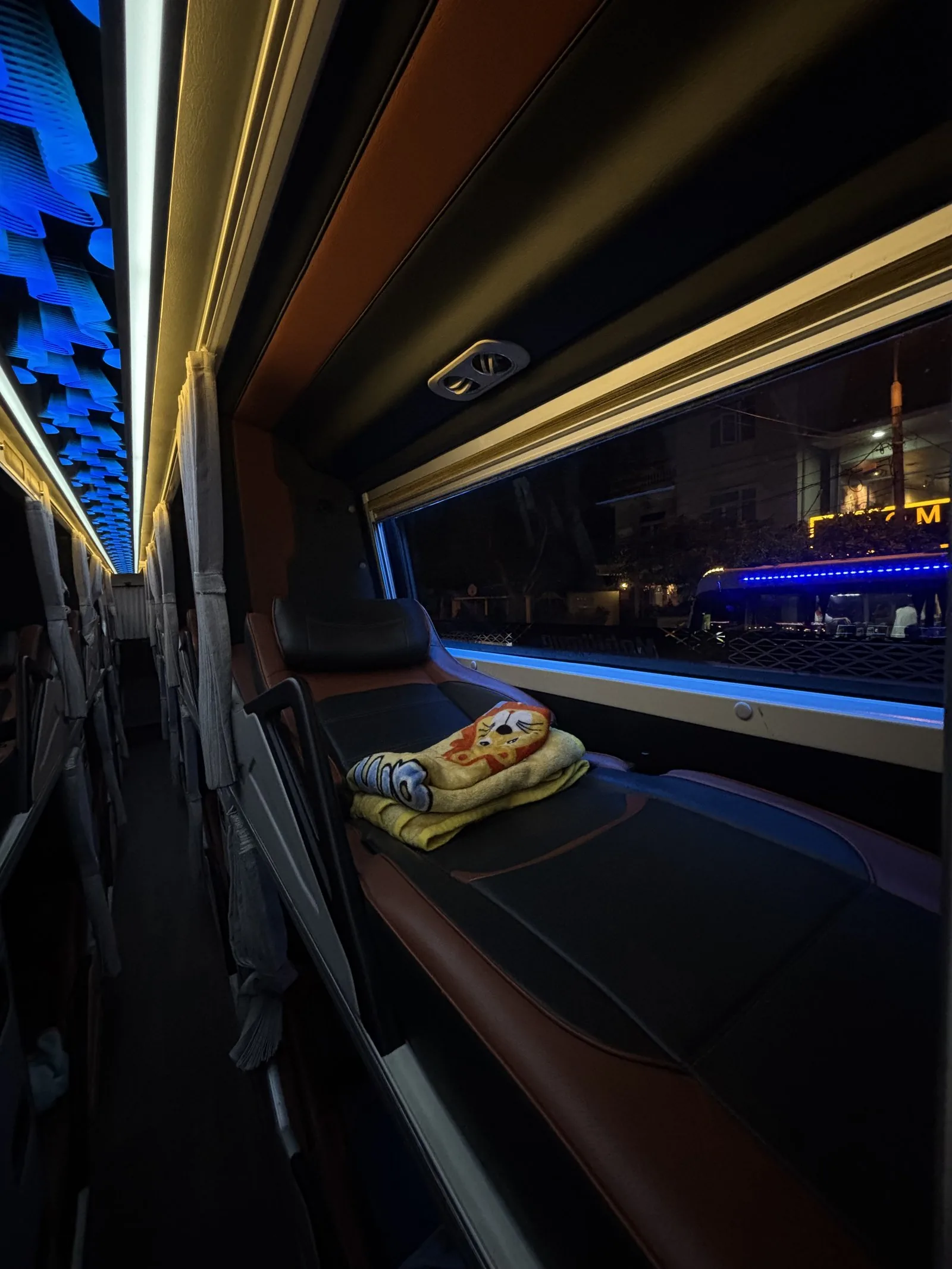 Sleeper bus berth — king-size bed with a privacy curtain